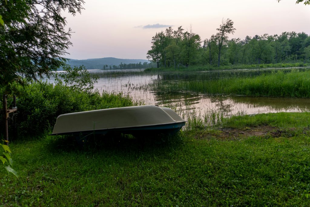 Remote boat ramp on a forested lake surrounded by national forest trees and mountains